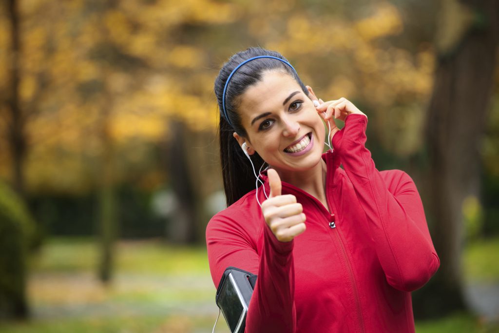 Successful female runner with earphones